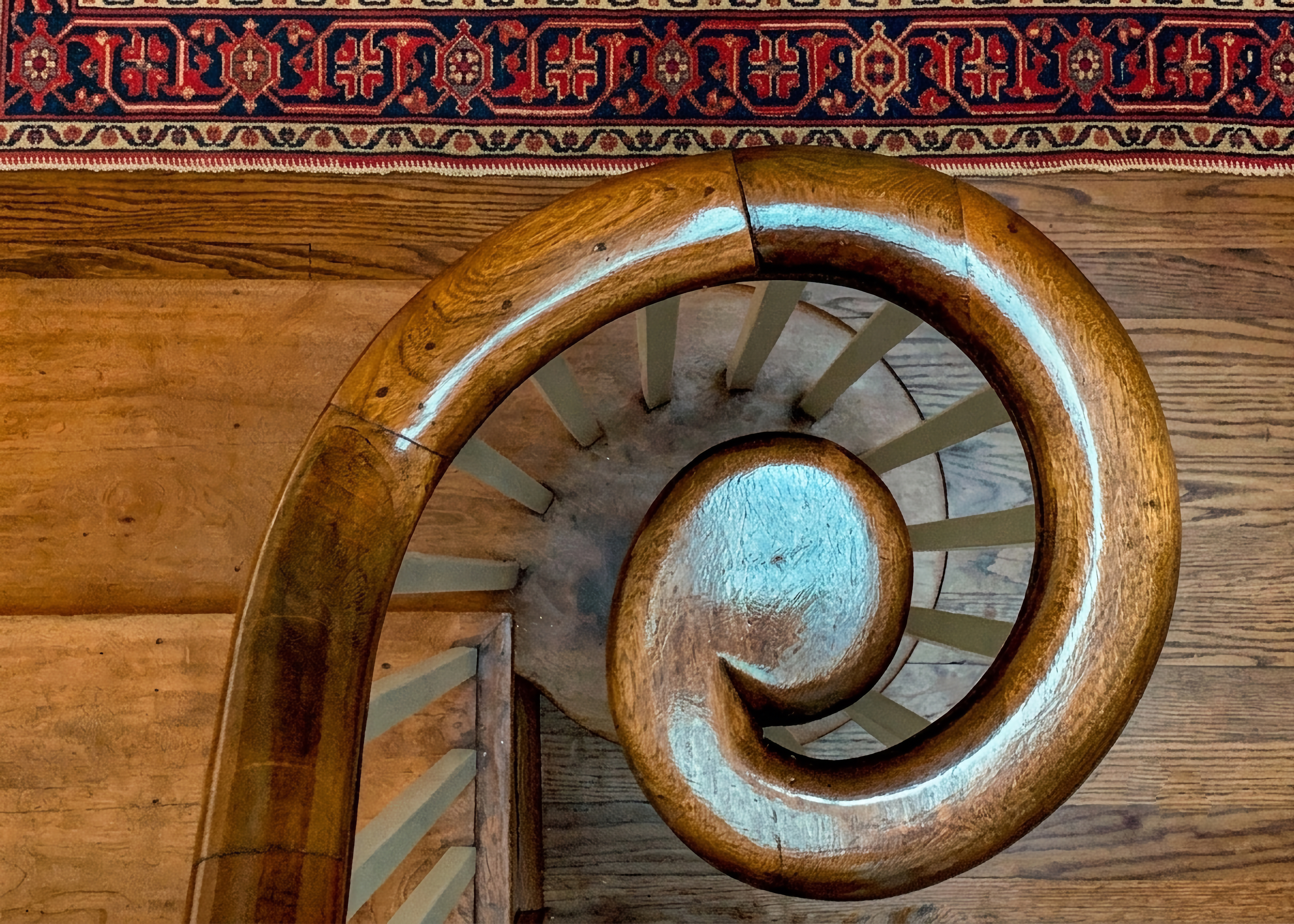 Curved wood staircase railing in a historic home